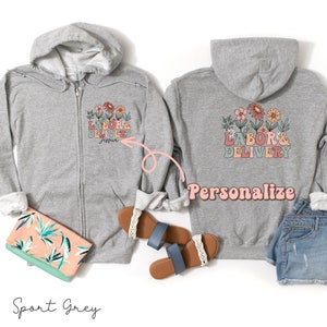 Gray zip-up hoodie with hood and colorful floral “Labor & Delivery” text