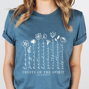 Blue floral graphic T-shirt with white plant text 'FRUITS OF THE SPIRIT'