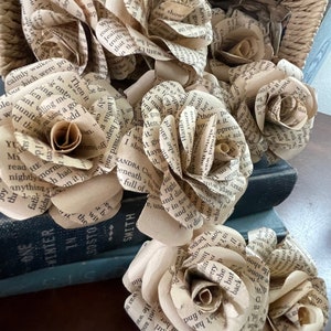 Dozen paper roses made from vintage book pages, clustered beige cream flower heads
