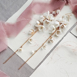 Long drop white floral wedding earrings with gold-tone chain links