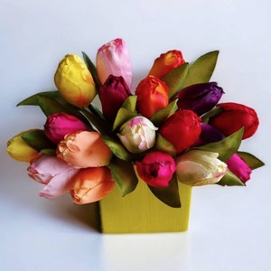 Artificial mixed tulip bouquet in yellow vase with pink, red, purple, and cream blooms