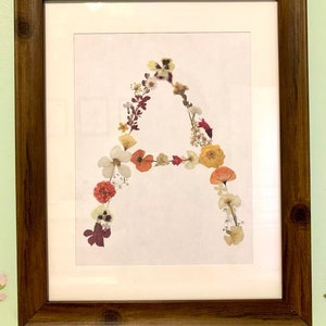 Framed pressed flower letter art print with multicolor floral letter design