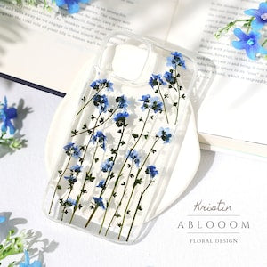 Clear phone case with pressed blue flowers and transparent protective cover