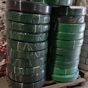 Coiled green flexible aluminum tubing for giant flower stems, 20mm diameter