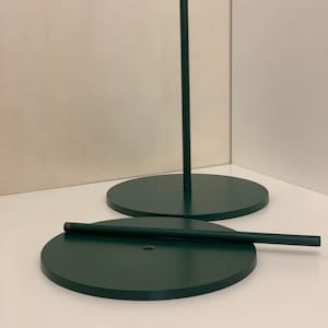 Metal flower stand base with round base, vertical pole, and horizontal support bar