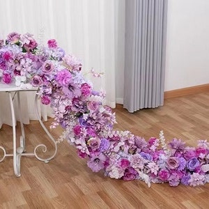 Purple and pink flower runner garland with layered blooms and small white flowers