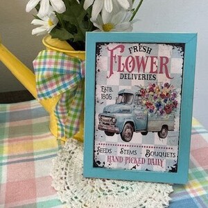 Framed wood flower delivery sign with text and floral truck illustration