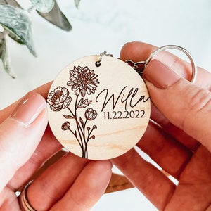 Round personalized birth flower keychain with engraved flower, name and date; metal key ring