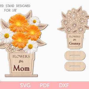 Laser-cut flower holder stand with orange flower cutouts and interchangeable name plaques