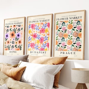 Set of three framed flower market prints with colorful blooms and city names: Rome, Budapest, Prague