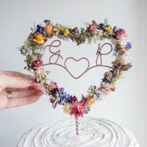 Floral heart cake topper with initials, dried flowers on metal stem