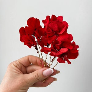 Burgundy dried flower hair pins with red hydrangea-style blooms