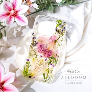 Pressed flower phone case with clear background and pink wildflower and green leaf design