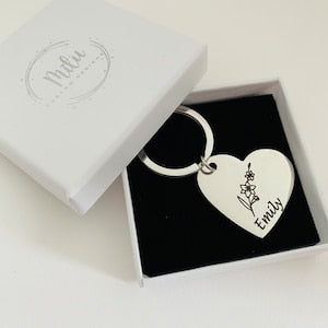 Personalized metal keychain with engraved heart charm and flower motif, in gift box
