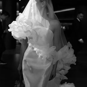 Ivory sheer bridal veil with layered flower appliques along the edges