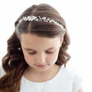 Girls pearl hair vine headpiece with small crystal accents, worn across the hairline