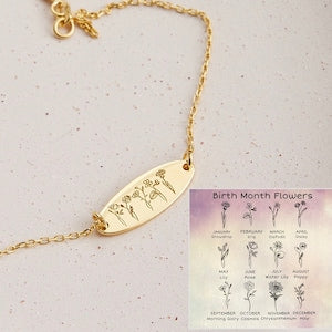 Gold-tone birth month flower bracelet with oval charm and engraved month flower icons