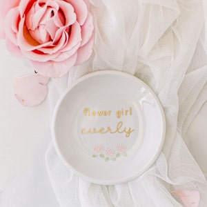 Personalized round jewelry dish with 'Flower girl lovely' text and floral design