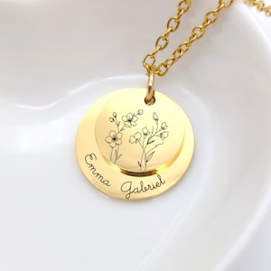 Gold-tone round locket necklace with engraved birth-flower line art and name