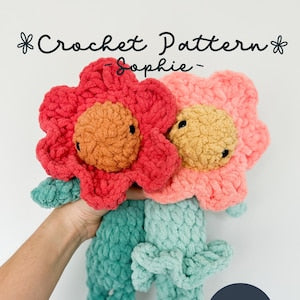 Crochet amigurumi flower lovey pattern, two hibiscus plushes in pink, teal and tan