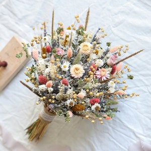 Dried flowers bouquet with peach and lavender pastel blooms and wrapped stems
