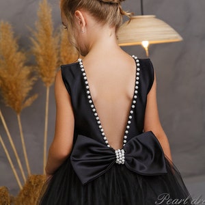 Girls black dress with pearl-trim straps and bow back