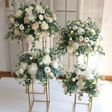 White and green floral ball arrangements on standing frames with leafy accents