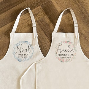 White personalized apron set for flower girl with name, date, and floral watercolor