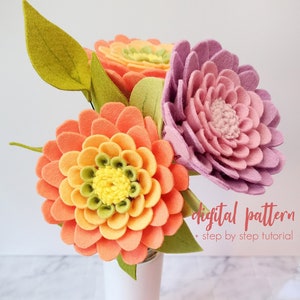 Felt flower bouquet with orange, pink, and purple zinnia blossoms and green leaves