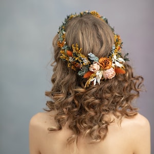 Floral flower crown headpiece with terracotta and peach blossoms, gold accents, worn on hair