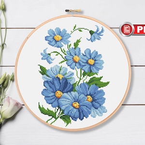 Blue forget-me-not flower bouquet cross stitch pattern in embroidery hoop