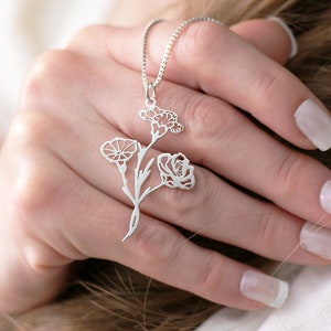 Silver-tone floral bouquet necklace with dangling flower and leaf pendant