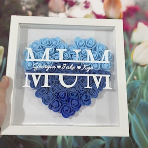 White shadowbox frame with blue rose heart, monogram letters MUM and cursive names