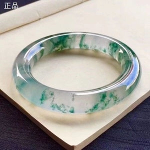 Light green and white jadeite round bangle bracelet with translucent carved look