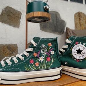 Embroidered high-top sneakers in dark green with colorful floral stitching and white laces