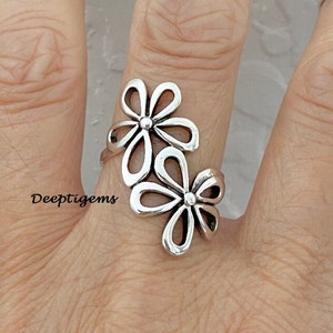 Sterling silver statement ring with two flower-shaped cutout designs