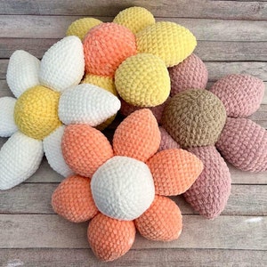 Crochet flower-shaped pillows in pastel colors, textured yarn petals