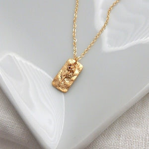 Gold birth flower pendant necklace with small floral charm on thin chain