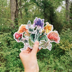 Flower fae vinyl sticker set of 3: die-cut fairy and floral designs, held in hand