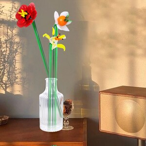 Lampwork glass flower bouquet with colorful long stems in a clear glass vase