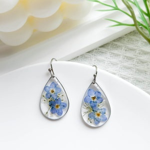 Teardrop dangle resin flower earrings with pressed blue forget-me-not blooms