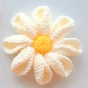 Crochet flower with cream petals and a yellow center