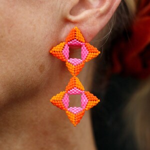 Beaded flower drop earrings with orange and hot pink geometric blooms