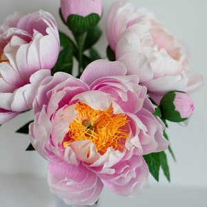Blush and cream crepe paper peony bouquet with detailed layered petals and green leaves
