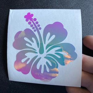Hibiscus flower vinyl sticker with purple petals and teal center on clear backing