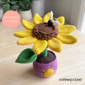 Crochet sunflower amigurumi flower in pot with bee and green leaves