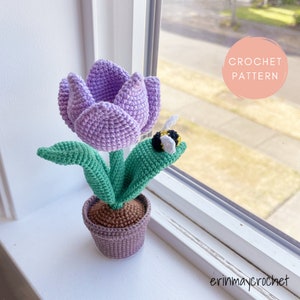 Crochet amigurumi tulip flower with green leaves and small bee in a pot
