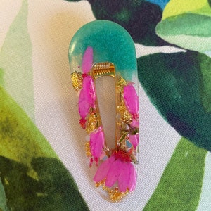 Gold-tone drop earrings with pink crystal teardrops and green center bead
