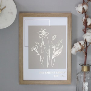 Framed birth flower family print with white line-art bouquet and decorative border