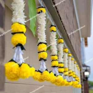 Artificial jasmine and marigold flower garlands with white and yellow tassels